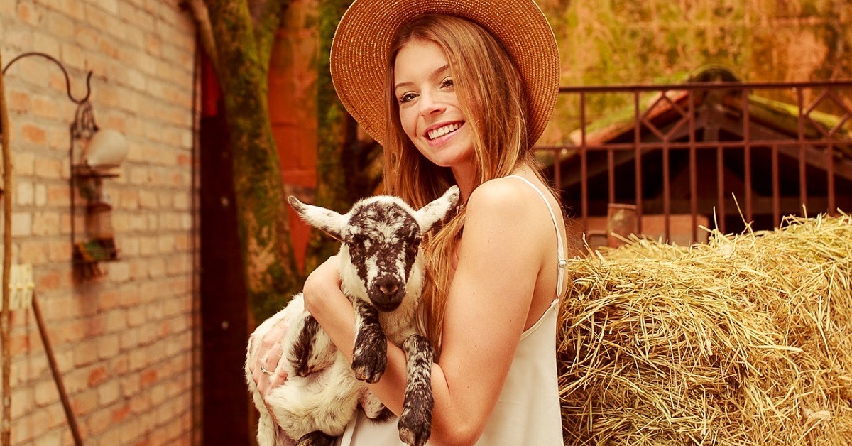 A woman holding a goat